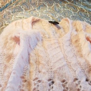 Pale pink hand knit sweater.